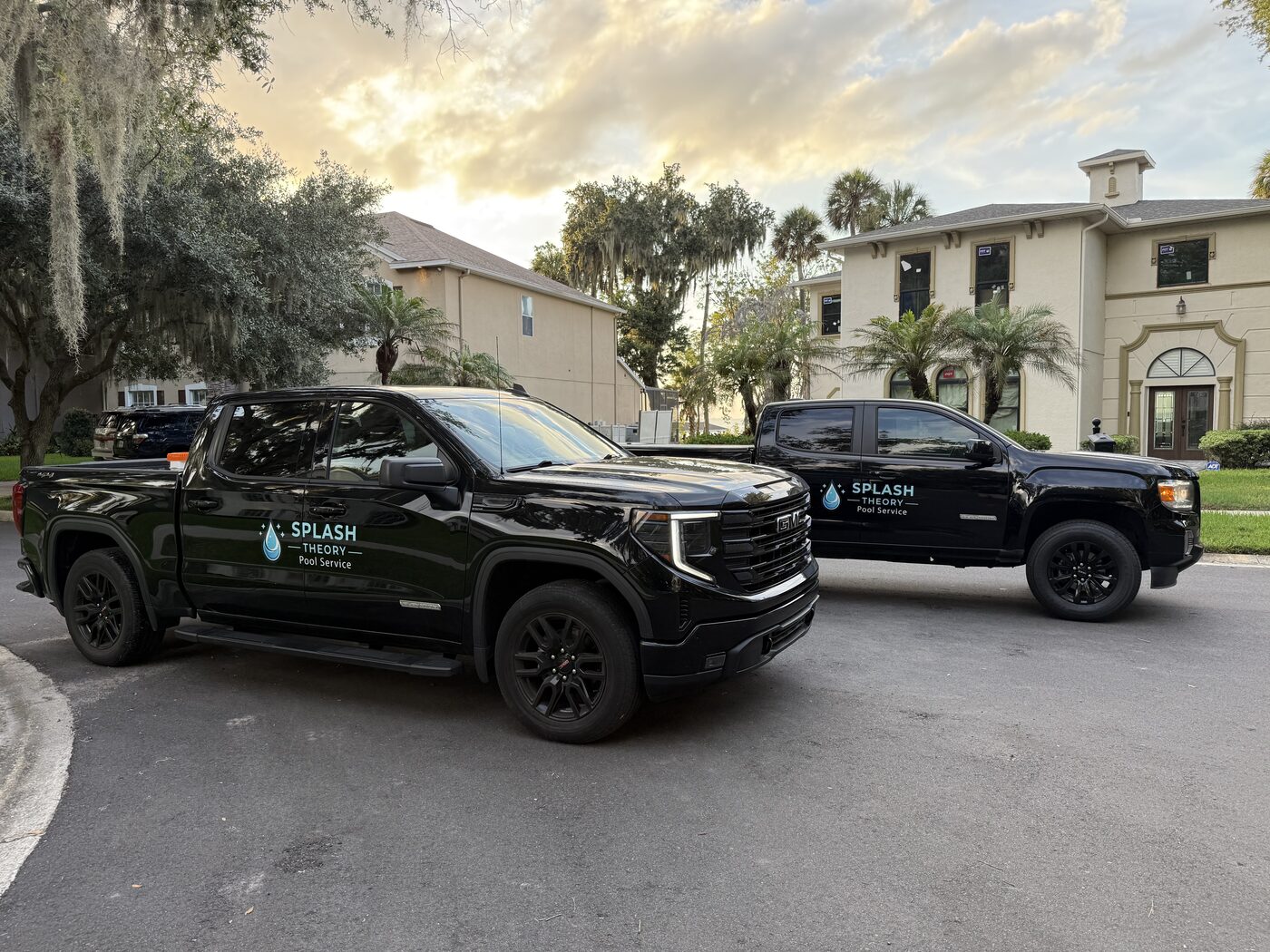 Two Splash Theory Pools branded black GMC trucks